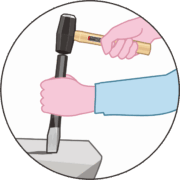 タガネをセットハンマーで叩いて石を割っているイラスト